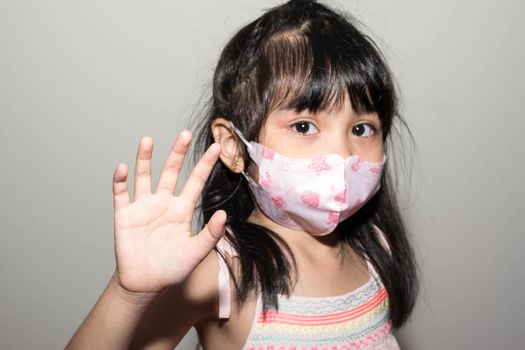 Kids hand to say no against corona virus infection. Blurry image of a female kid showing her hand to symbolize against the spread of corona virus