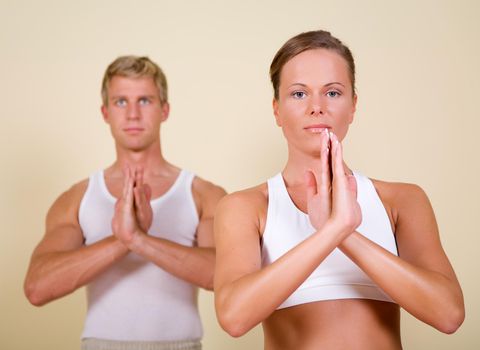 Couple (male / female) doing yoga exercises together