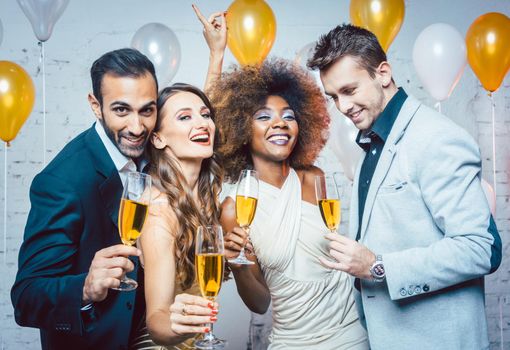 Group of party people celebrating with drinks a birthday or New years eve party