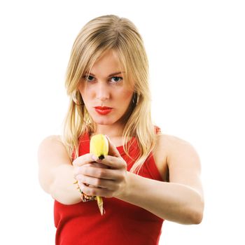 Blond girl using a banana like a gun threatening the viewer