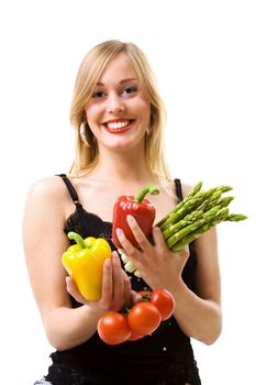 Sweet girl holding pepper, asparagus and tomatoes