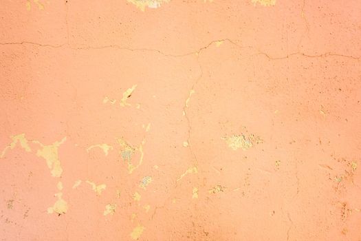 Old pink cracked stucco wall background texture