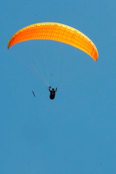 porto seguro, bahia / brazil - february 7, 2008: Paragliding pilot is seen during flight at Taipe beach in the Trancoso district of Porto Seguro.