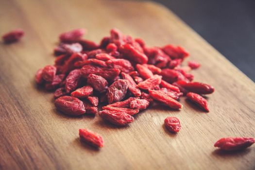 Goji berries on a wooden cutting board