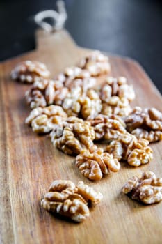 Walnut kernels on a wooden cutting board