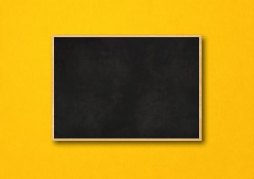 Traditional black board isolated on a yellow background. Blank horizontal mockup template