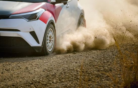 Rally racing car on dirt road.