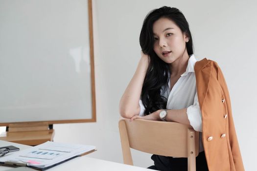 Portrait Of Attractive Asian Businesswoman Working for marketing plan.
