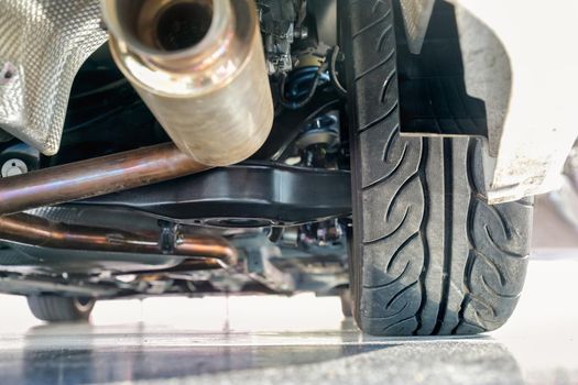 Car suspension and exhaust pipe