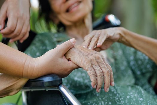 Elderly asian woman on wheelchair at home with daughter take care