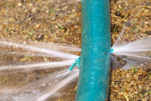 water leaking from hole in a industrial hose.