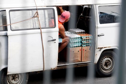 salvador, bahia / brazil - july 12, 2018: egg seller is seen in a kombi vehicle in the city of Salvador.
