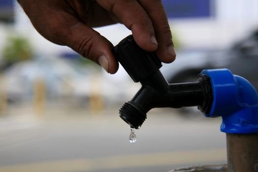 salvador, bahia, brazil - february 19, 2021: drop of water coming out of a tap in the city of Salvador. the image symbolizes lack of water.