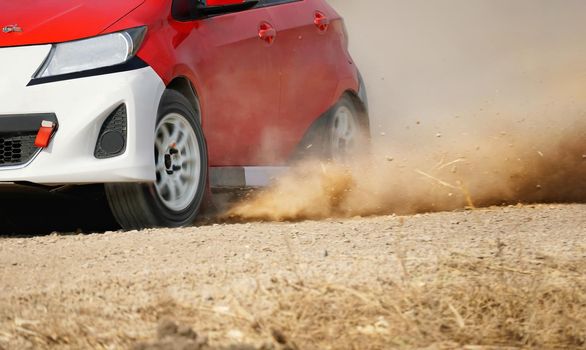 Rally racing car on dirt road.