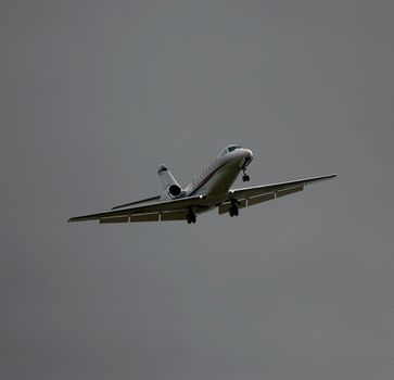 porto seguro, bahia / brazil - july 18, 2014:  executive jet is seen during landing procedure on the runway of the airport of the city of Salvador.