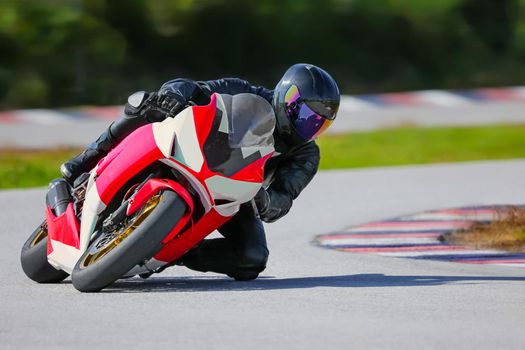 Motorcycle leaning into a fast corner on race track