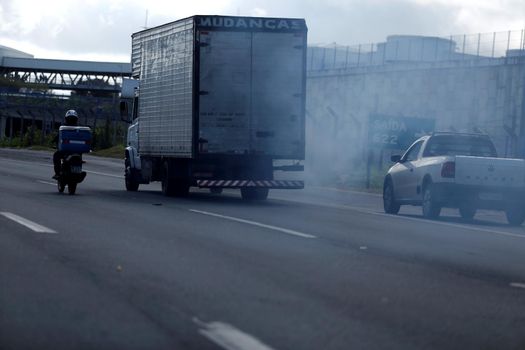 salvador, bahia / brazil - august 21, 2018: smoke is seen coming from the exhaust system of a truck that passes through highway BR 324 in the city of Salvador.


