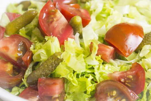 Lettuce salad with tomato and pickles. Raw food