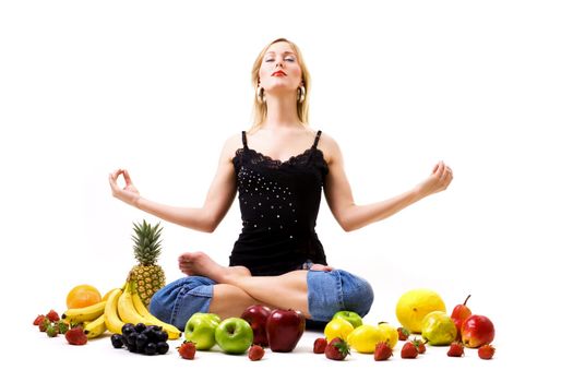 Food, fruit and healthy nutrition - blond girl seeking enlightenment amidst a lot of fruit