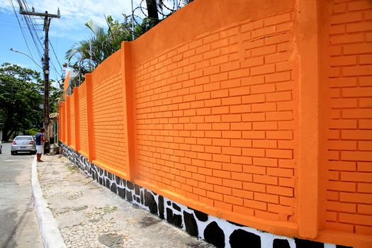 salvador, bahia, brazil - december 21, 2020: wall made of brick and painted orange is seen in the neighborhood of Itapua, in the city of Salvador.