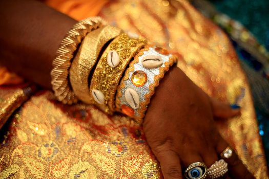 salvador, bahia / brazil - february 2, 2020: bracelet is seen on a woman's arm during a party in honor of the orisha Yemanja on the rio Vermelho beach, in the city of salvador.
