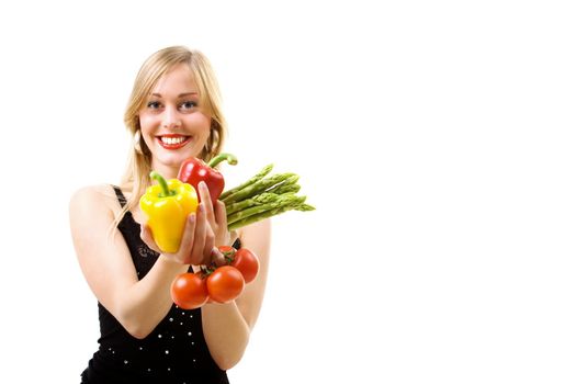 Blond girl holding vegetables in her hands