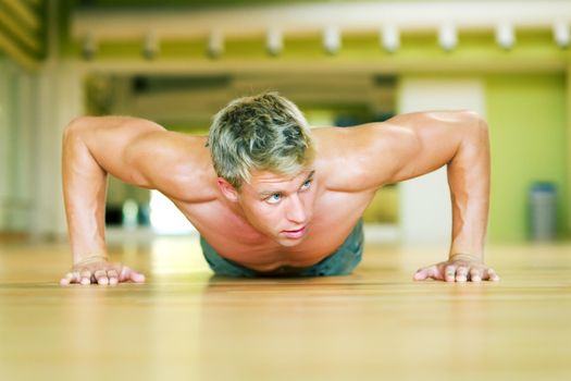 Strong, handsome man doing push-ups