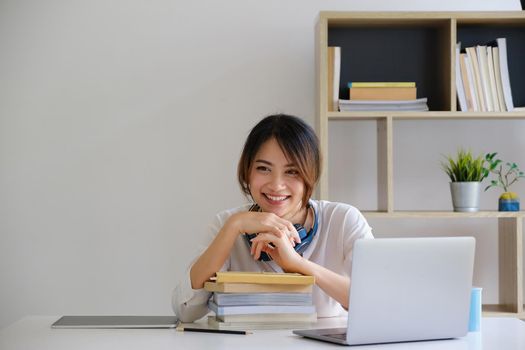 Female executive thinking over working schedule for employee writing report into digital laptop in coworking space