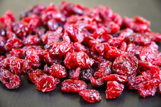 Dried bunch of organic cranberries on a kitchen table.