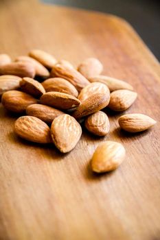 Fresh organic almonds on a wooden cutting board