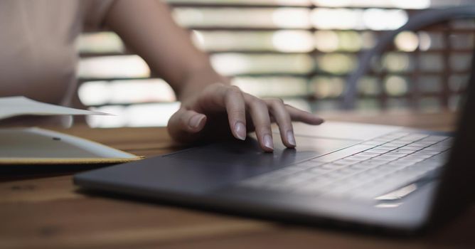 Close up Woman working at home office hand on keyboard for working or learning online.