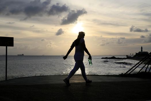 salvador, bahia, brazil - january 22, 2021: farm person walking during physical activity in Barra neighborhood in the city of Salvador.