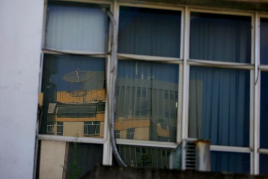 salvador, bahia / brazil - september 23, 2015: reflections of the street are seen in a mirrored building in the city of Salvador.