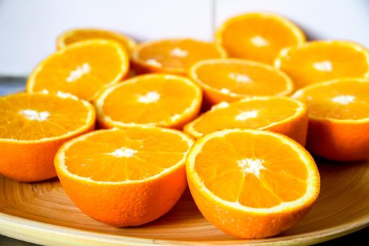 Bunch of fresh organic sliced oranges on a tray