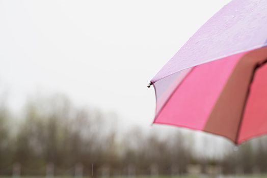 Rain drops on a colorful umbrella. Close up of colorful umbrella part with raindrops