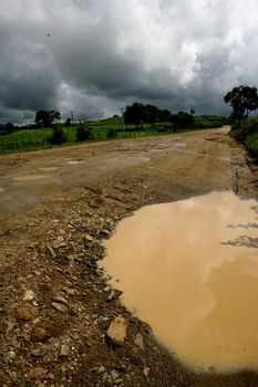 itabuna, bahia / brazil - november 22, 2011: mud and hole are seen on a dirt road leading to the district of Itamaraca, in the municipality of Itabuna, in southern Bahia.