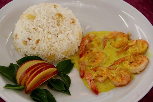 prado, bahia / brazil - october 20, 2012: Grilled VM prawns, topped with curry sauce, with pineapple rice. Dish for sale in a restaurant in the city of Prado.