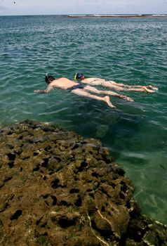 marau, bahia / brazil - december 27, 2011: People are seen diving in a natural pool on the beach of Taipu de Fora, in Barra Grande district, in the municipality of Marau.