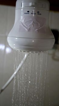 salvador, bahia brazil - may 26, 2020: electric shower is seen on coming out of water.