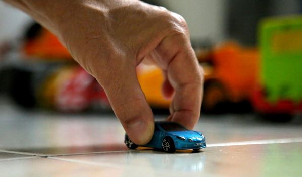 salvador, bahia brazil - may 26, 2020: hand holds replica of a miniature car.


