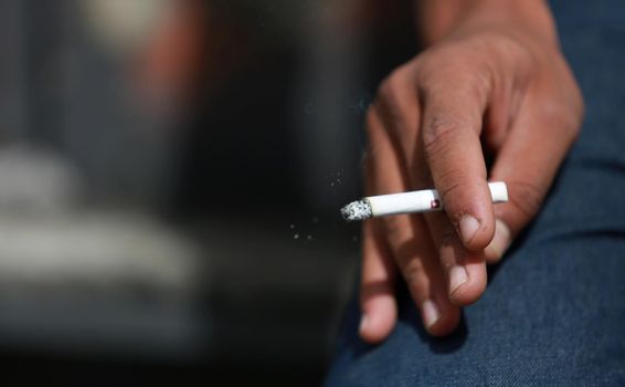 salvador, bahia / brazil - May 29, 2015: Young man is seen smoking a cigarette in the city of Salvador.