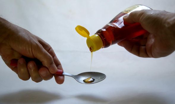 salvador, bahia / brazil - may 24, 2020: honey can pour content into spoon.