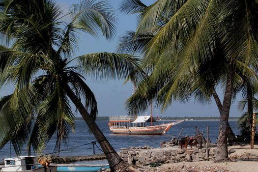 jandaira, bahia / brazil - december 24, 2013: boat is seen near the port of Mangue Seco, fishing village and tourist spot in the city of Jandaira.
