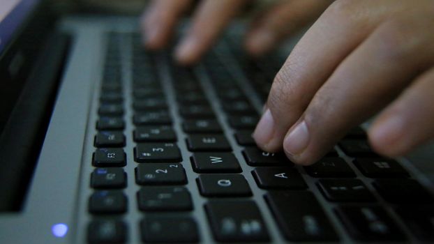 salvador, bahia / brazil: 03/30/2020: person uses computer keyboard to access the internet