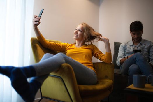 couple at home looking at their smart phones