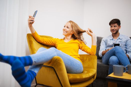 couple in love taking selfie and smiling at home