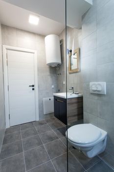 modern toilet interior with glass shower