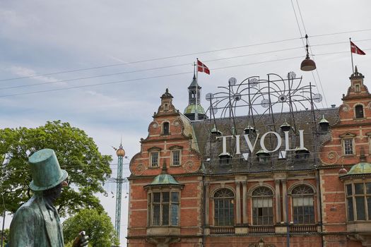 COPENHAGEN, DENMARK - JUNE 28, 2017: Statue of H. Ch. Andersen and Tivoli amusement park in Copenhagen, Denmark.