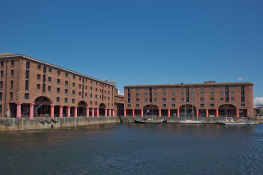 LIVERPOOL, ENGLAND, UK - JUNE 07, 2017: View of Albert Dock in Liverpool, England. The Albert Dock is a complex of dock buildings and warehouses. First non-combustible warehouse system in the world.