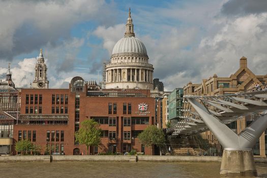 LONDON, UK - SEPTEMBER 08, 2017: St Pauls Cathedral and the Millennium Bridge in London, United Kingdom during a cloudy day.